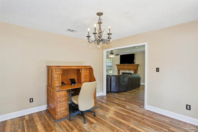 2724 Ashbury Ln, Cantonment, FL 32504 - office area featuring a chandelier, a fireplace, wood finished floors, a textured ceiling, and ceiling fan
