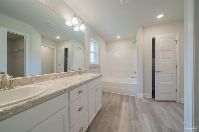 bathroom with vanity, shower / tub combination, and wood-type flooring