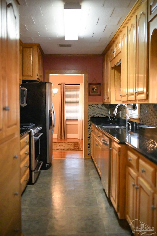 kitchen featuring stainless steel appliances, tasteful backsplash, and sink