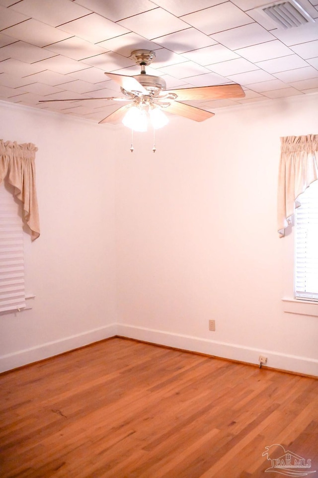 empty room featuring ceiling fan and hardwood / wood-style floors