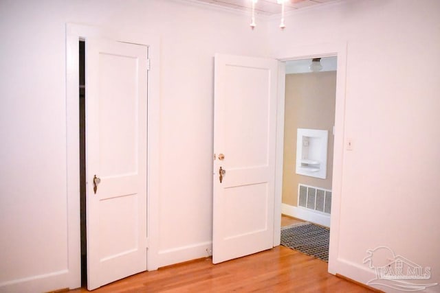 unfurnished bedroom featuring light wood-type flooring