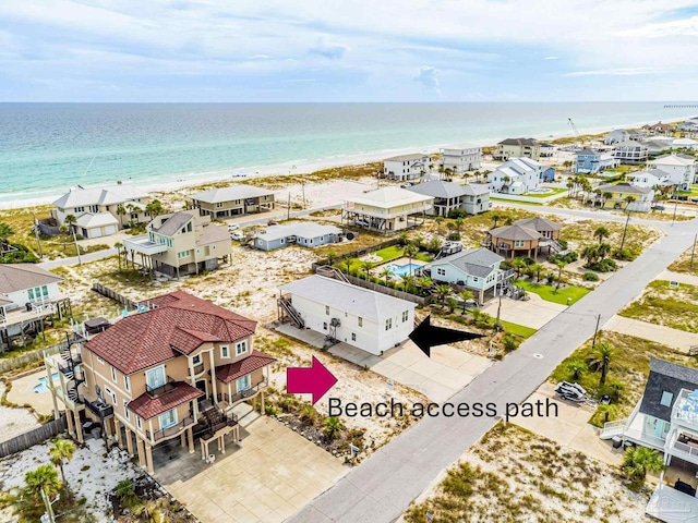 bird's eye view featuring a water view and a beach view