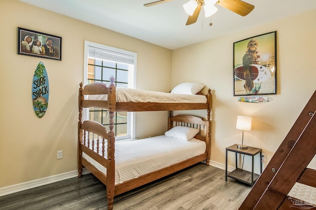 bedroom featuring ceiling fan, wood-type flooring, and multiple windows