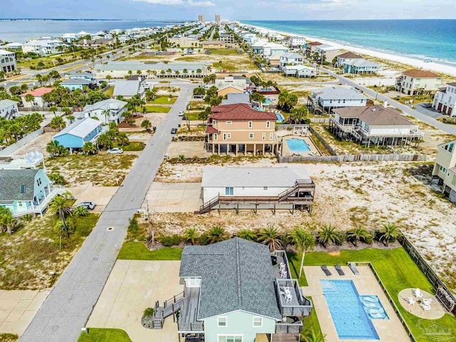 birds eye view of property with a water view and a view of the beach