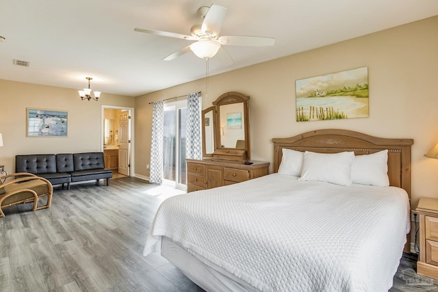 bedroom with ensuite bathroom, light wood-type flooring, and ceiling fan with notable chandelier