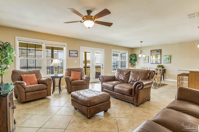 tiled living room with ceiling fan