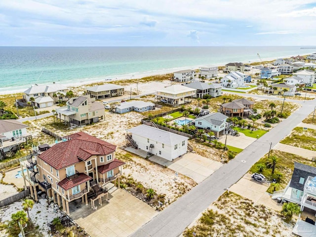 birds eye view of property featuring a water view and a beach view