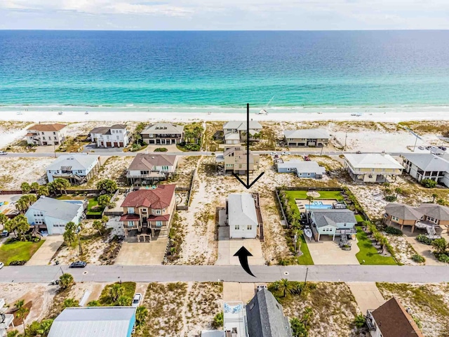 drone / aerial view featuring a water view and a beach view