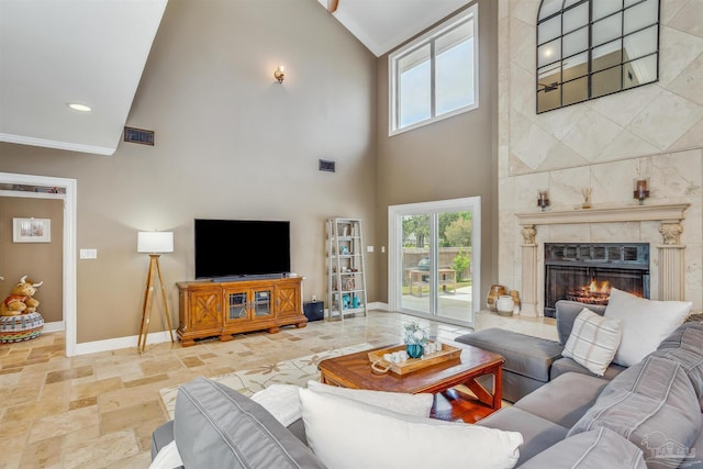 living room featuring ornamental molding, high vaulted ceiling, and a fireplace