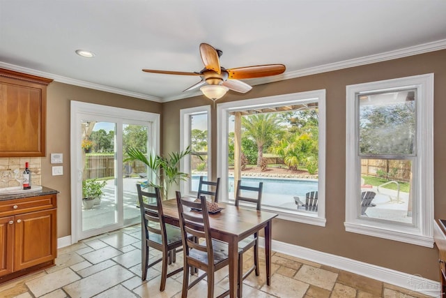 dining area with crown molding and ceiling fan