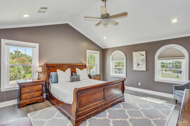 bedroom featuring vaulted ceiling, crown molding, ceiling fan, and light hardwood / wood-style flooring