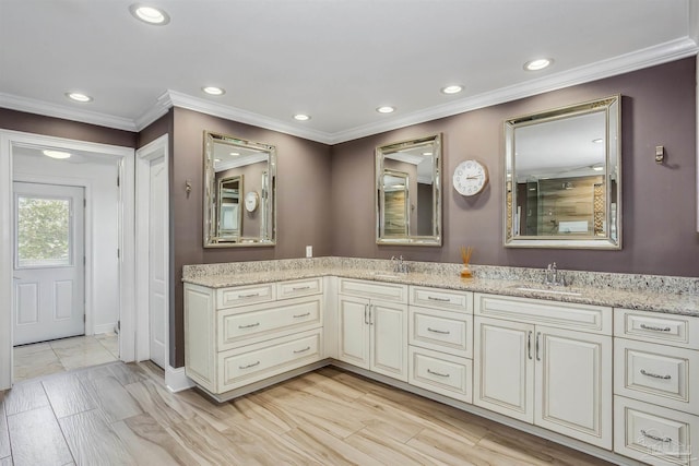 bathroom featuring crown molding and vanity