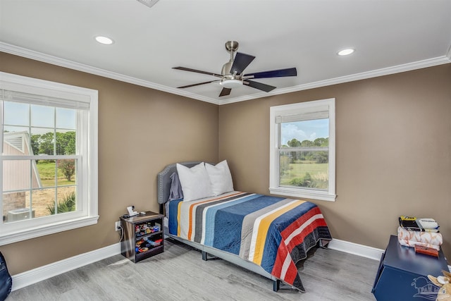 bedroom featuring crown molding, ceiling fan, and hardwood / wood-style floors