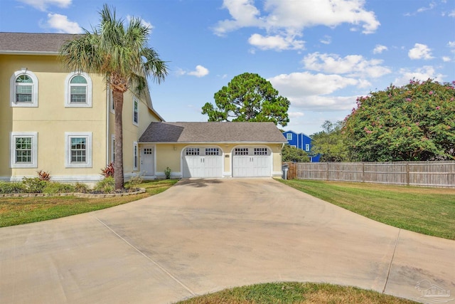 view of front of home with a garage and a front lawn