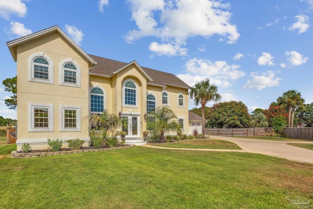 mediterranean / spanish house with french doors and a front yard