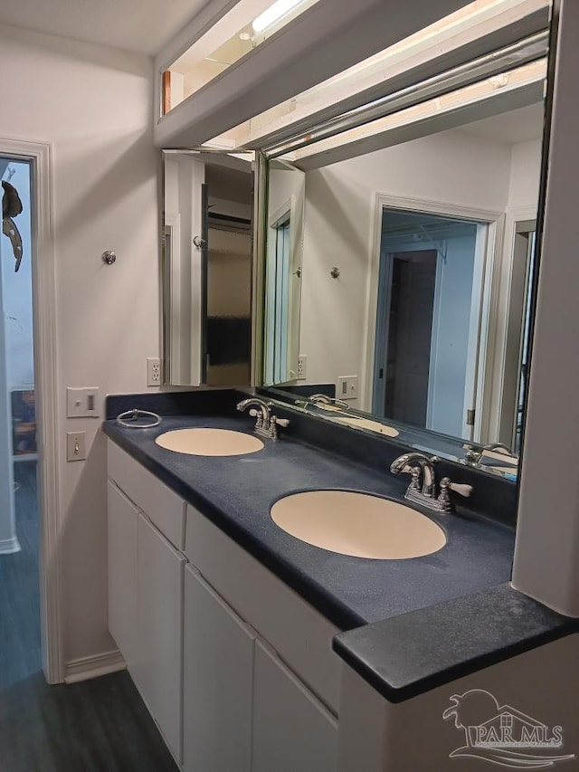 bathroom featuring vanity and hardwood / wood-style flooring