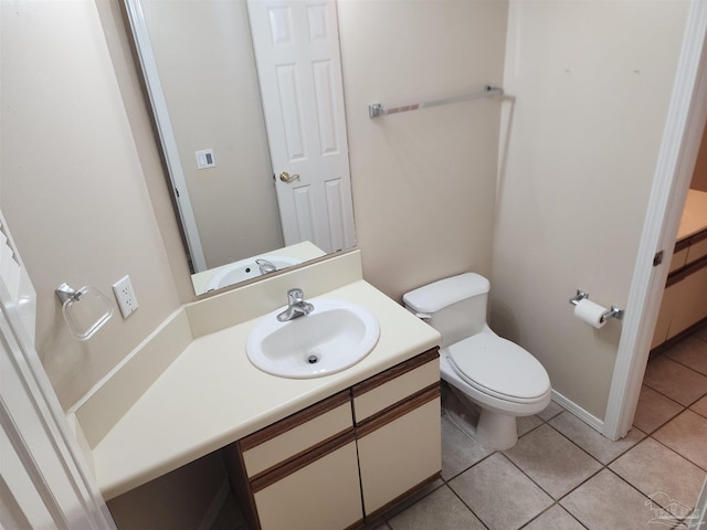 bathroom with vanity, tile patterned flooring, and toilet