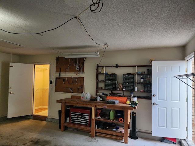 basement featuring a workshop area and a textured ceiling