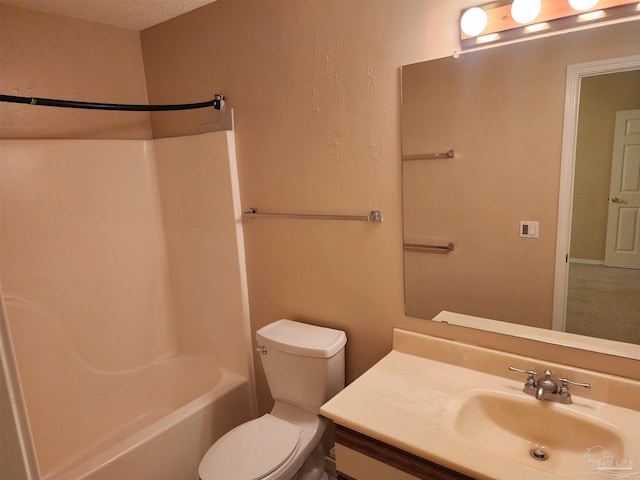 full bathroom featuring toilet, washtub / shower combination, vanity, and a textured ceiling