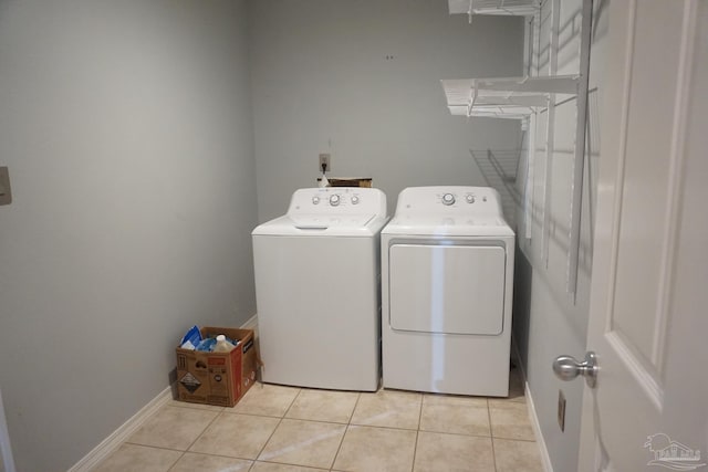 washroom with light tile patterned floors and washer and dryer