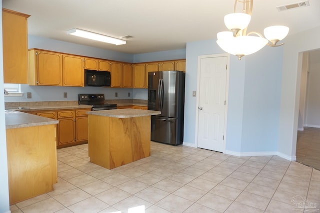 kitchen with sink, hanging light fixtures, a kitchen island, an inviting chandelier, and black appliances