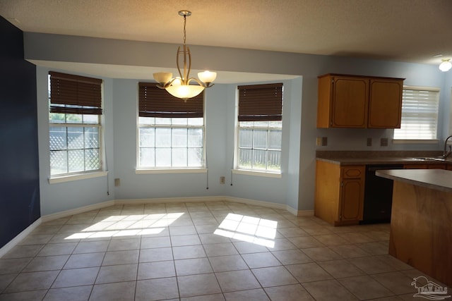 kitchen featuring a notable chandelier, dishwasher, hanging light fixtures, and light tile patterned floors