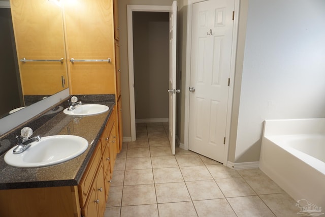 bathroom with vanity, a bathing tub, and tile patterned floors