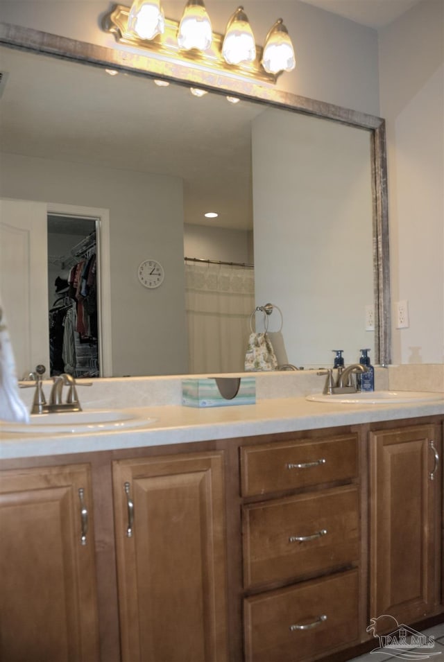 bathroom with vanity and curtained shower