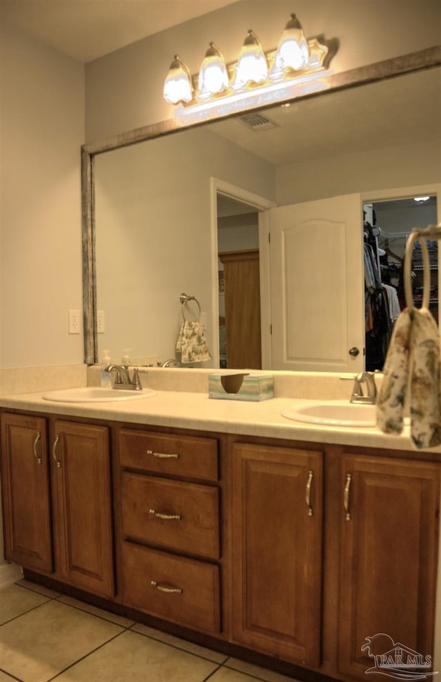 bathroom with tile patterned floors and vanity