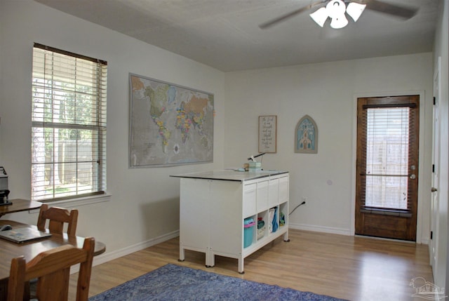 home office featuring ceiling fan, a healthy amount of sunlight, and light wood-type flooring