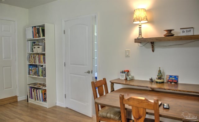 dining space with wood-type flooring