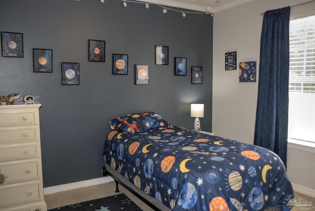 bedroom with crown molding and light carpet