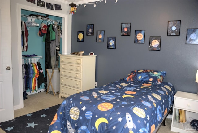 carpeted bedroom featuring ornamental molding and a closet