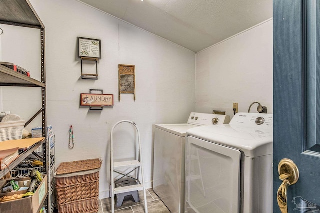 laundry area featuring tile patterned flooring and washing machine and clothes dryer