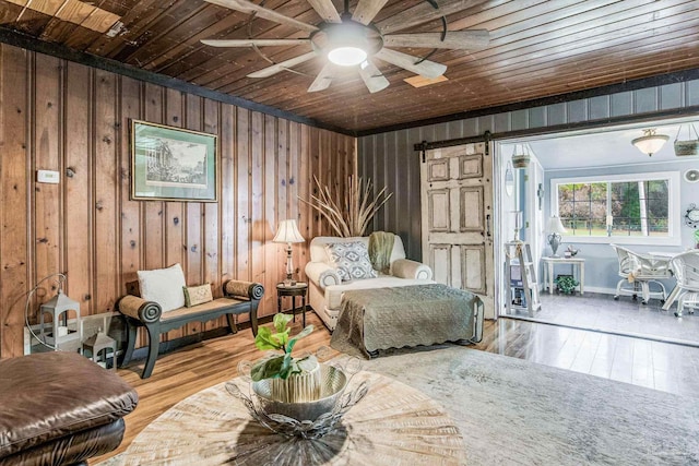 110 Glover Rd, Century, FL 32535 - living area with a barn door, wooden ceiling, wood-type flooring, a ceiling fan, and wood walls