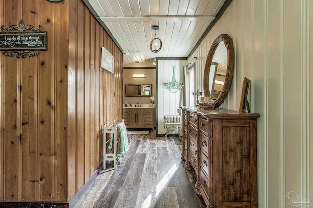 interior space with hardwood / wood-style floors, wooden ceiling, and wood walls