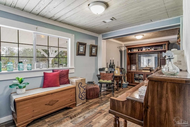 living area featuring dark hardwood / wood-style floors, ornamental molding, and wooden ceiling