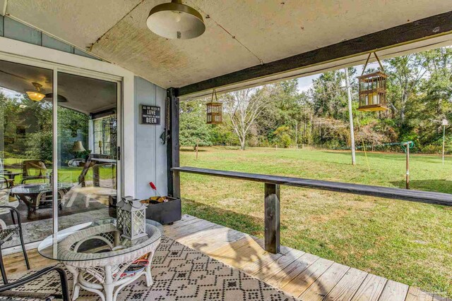 sunroom featuring vaulted ceiling