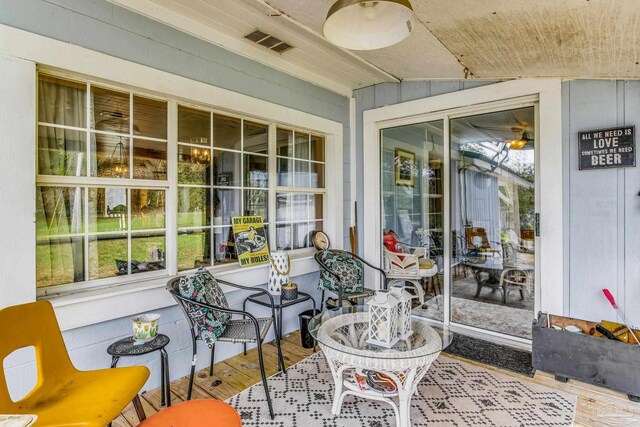 sunroom / solarium featuring vaulted ceiling