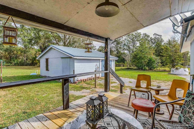 deck featuring an outbuilding and a yard