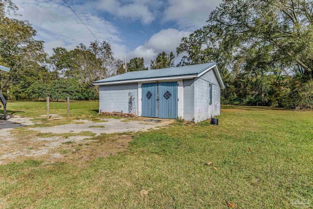 view of outbuilding featuring a yard