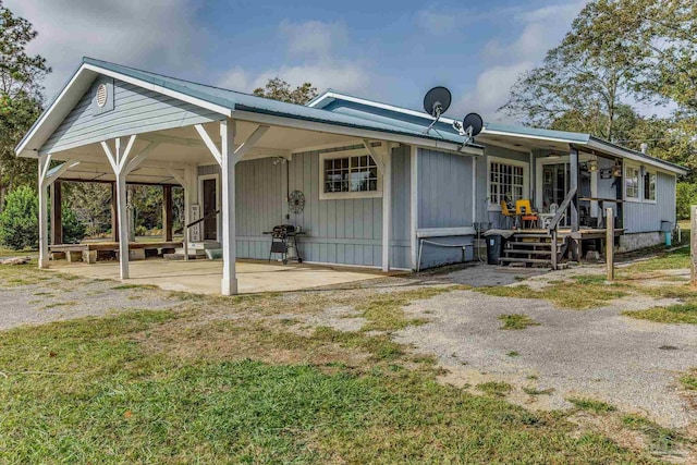 rear view of property featuring covered porch