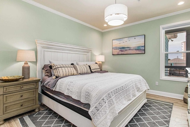 bedroom featuring crown molding, baseboards, wood finished floors, and recessed lighting