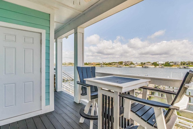 wooden terrace featuring a water view