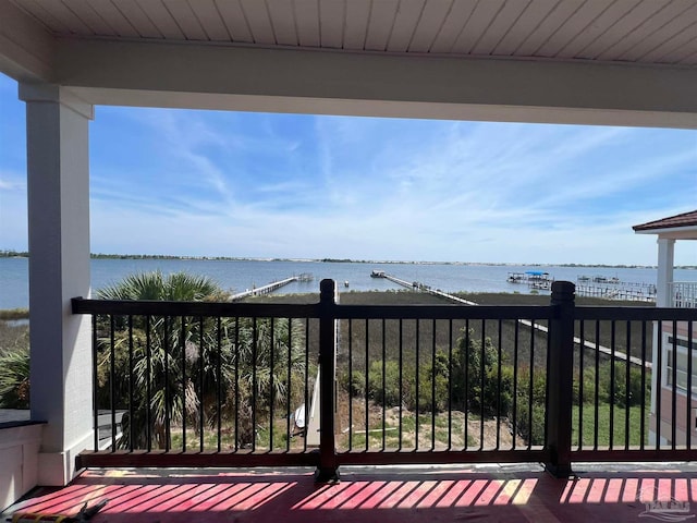 wooden terrace featuring a water view