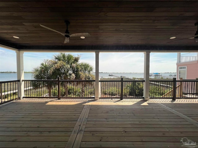 wooden deck featuring ceiling fan and a water view