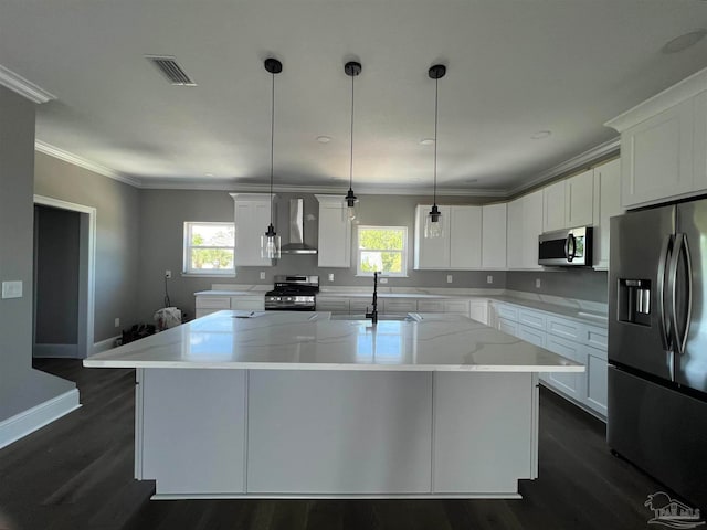 kitchen featuring white cabinetry, a center island with sink, stainless steel appliances, and plenty of natural light