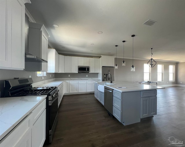 kitchen featuring white cabinetry, pendant lighting, dark hardwood / wood-style floors, and appliances with stainless steel finishes