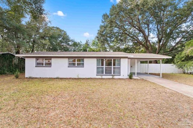 ranch-style home featuring a front yard and a carport