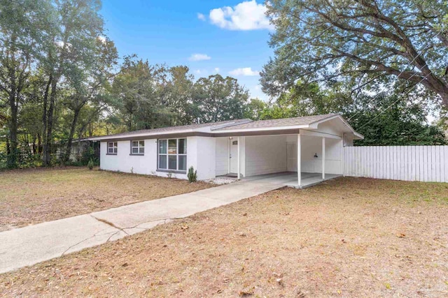 ranch-style house with a front lawn and a carport